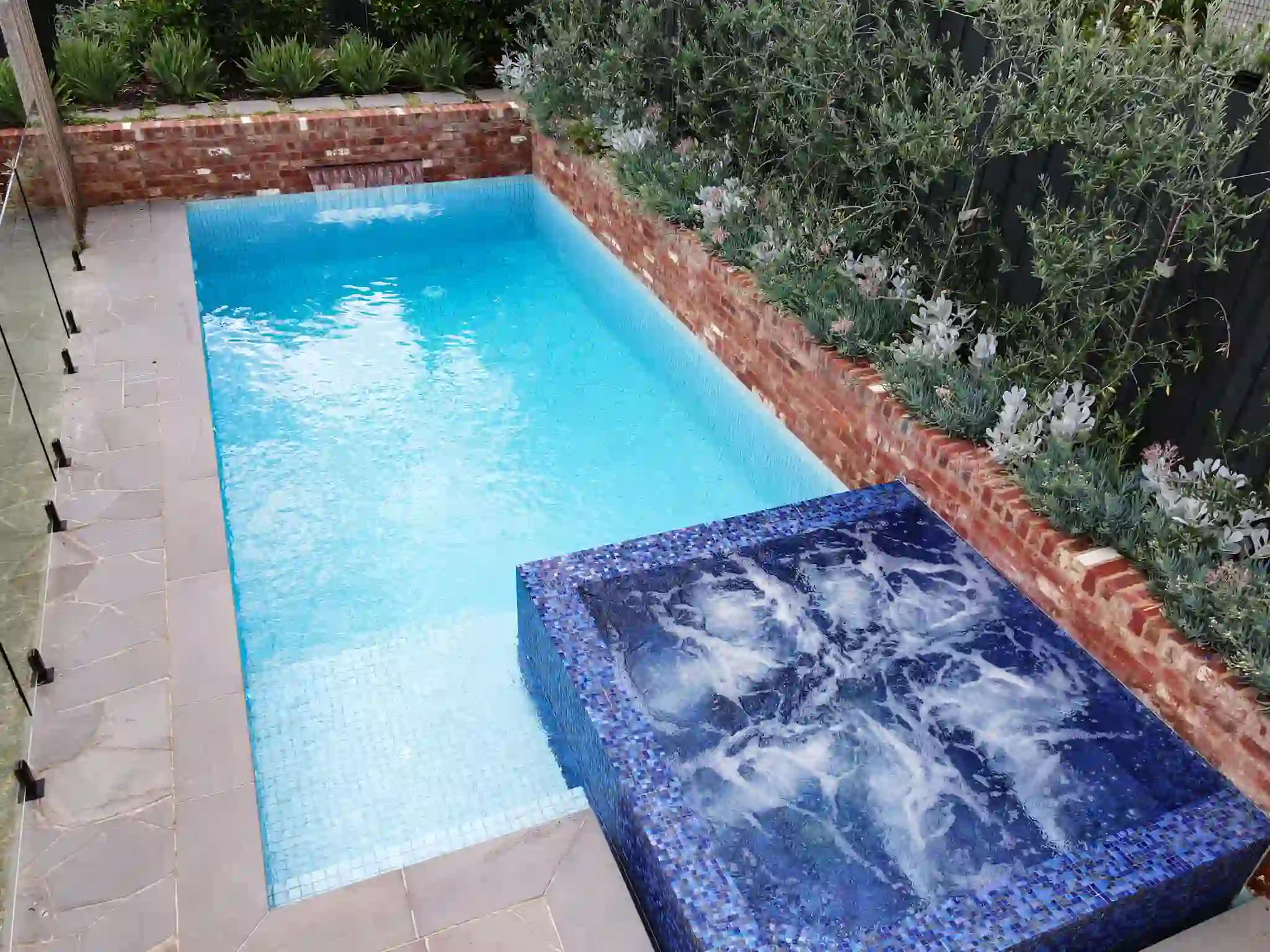 A small pool featuring a blue tile edge