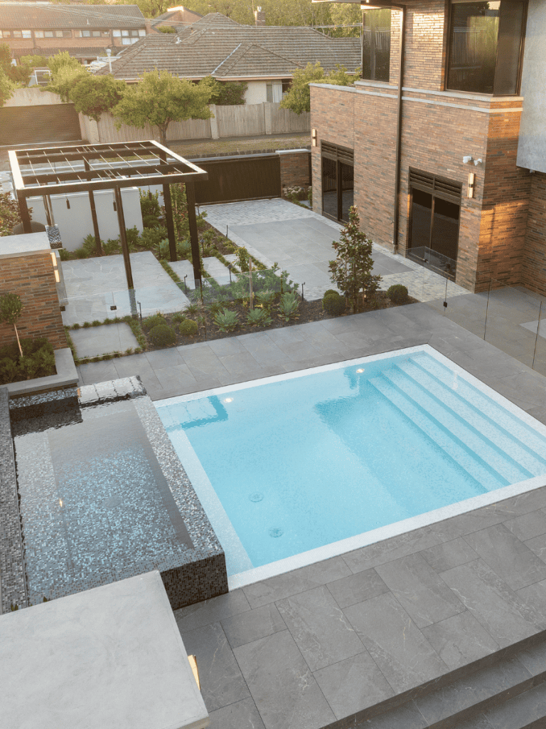 Modern backyard with in-ground swimming pool and landscaped garden.