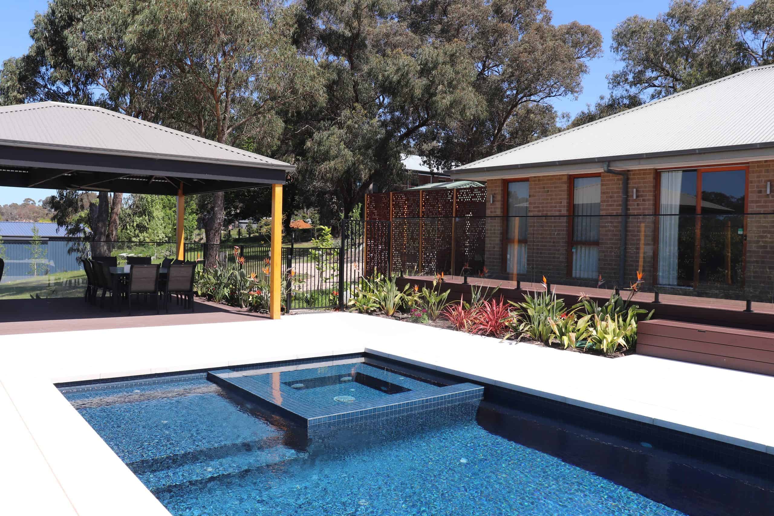 Modern backyard with in-ground swimming pool and outdoor entertaining area.