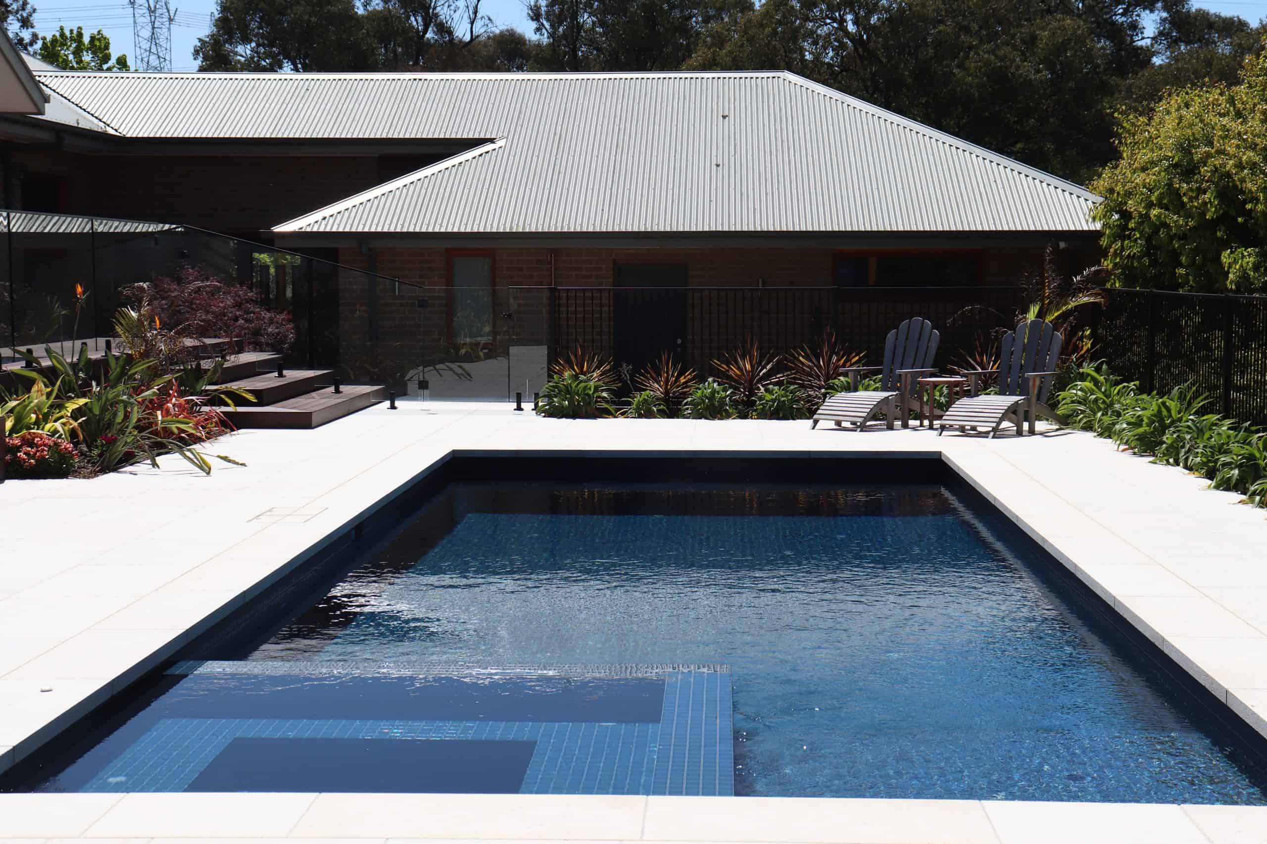 Modern backyard pool with surrounding deck and garden in Plenty 3.