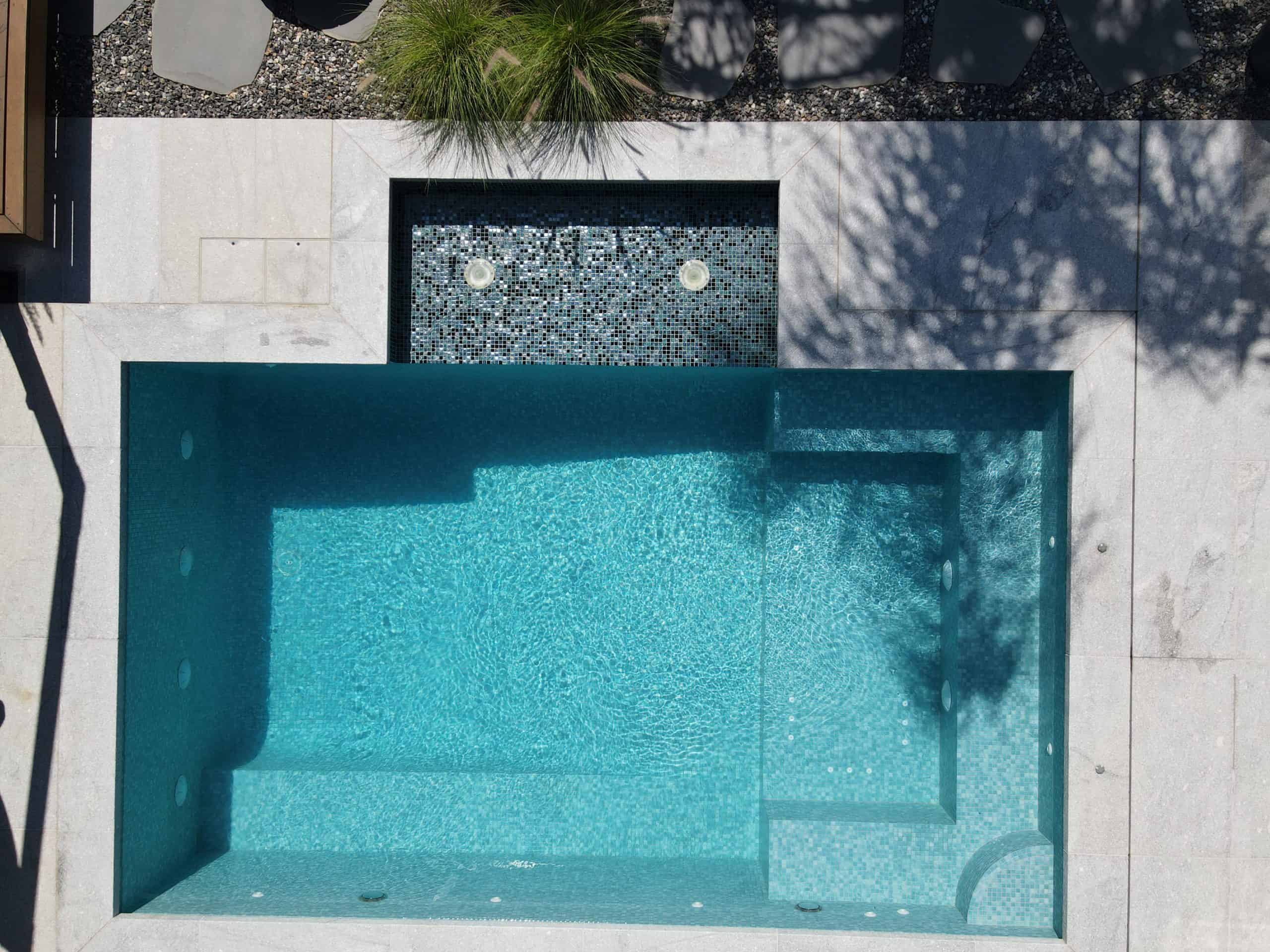 Modern rectangular swimming pool with built-in steps and water jets in South Morang.