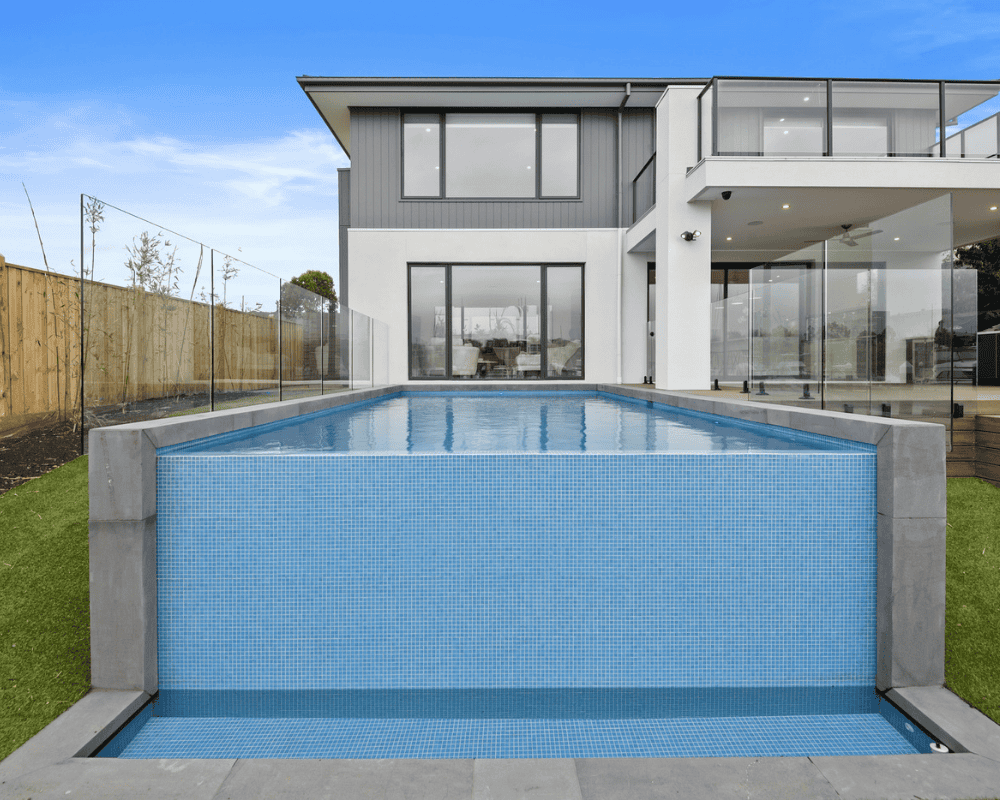 Modern backyard with infinity pool and contemporary house design in Australia.