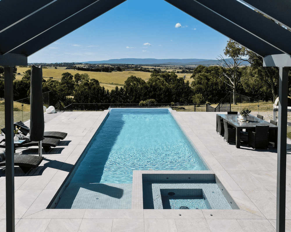 Modern backyard pool with spa and scenic countryside view in Australia.