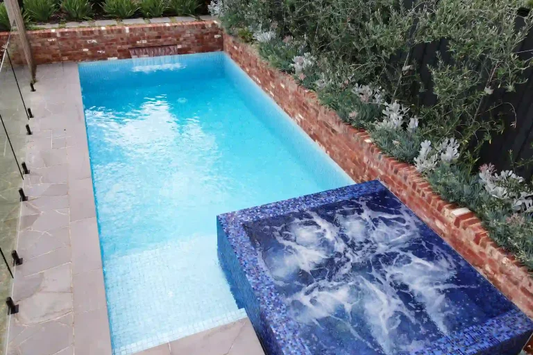 A small pool featuring a blue tile edge